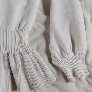 Cream peplum sweater